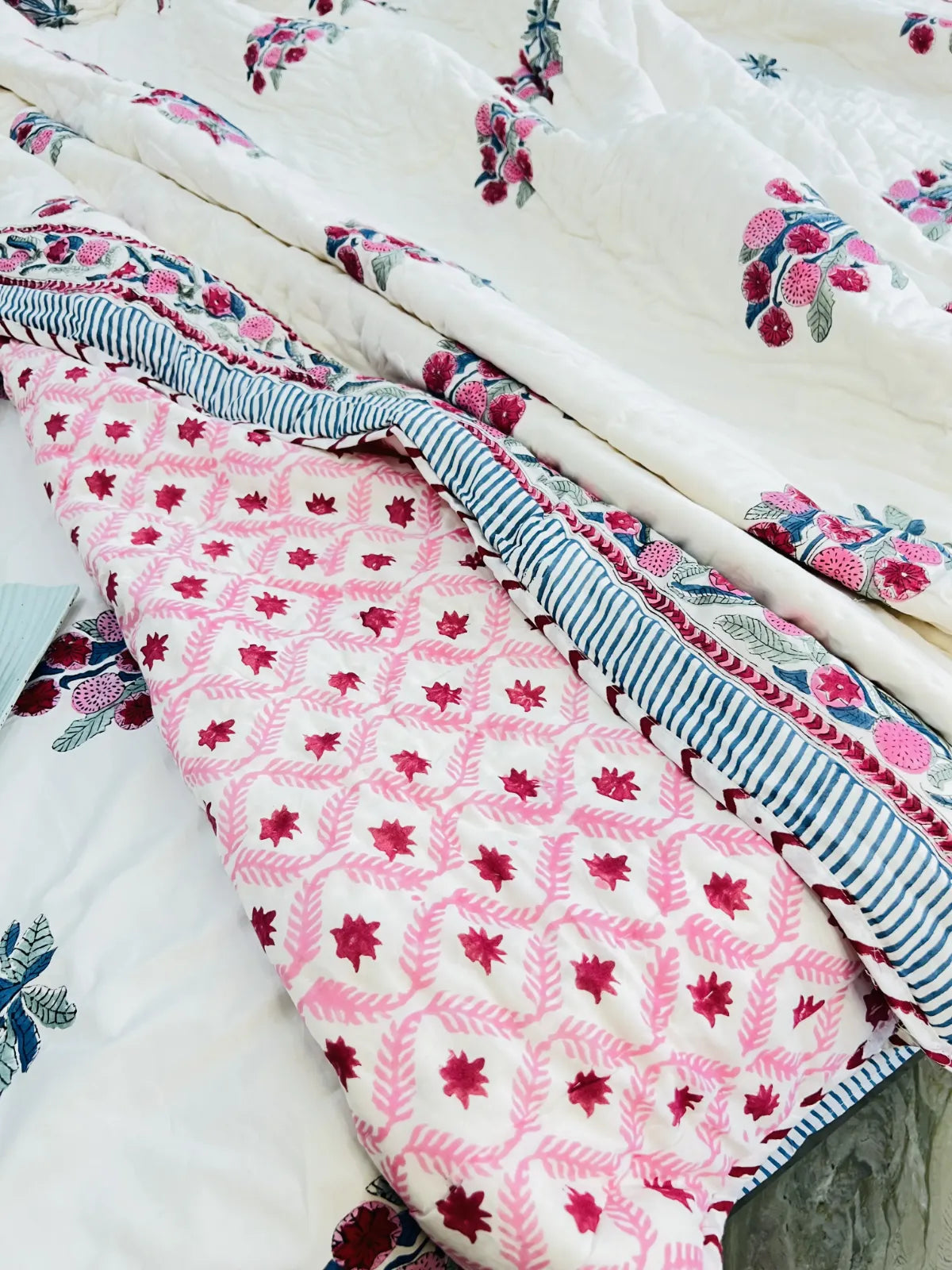 Stack of floral and patterned fabric pieces on a white background