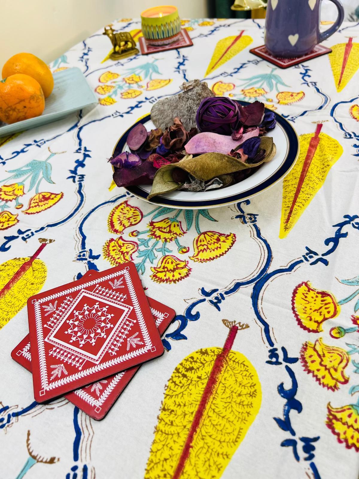 Colorful tablecloth with leaf patterns on a table setting
