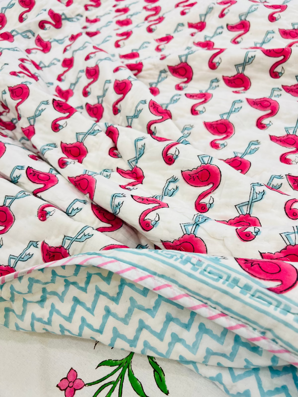 Floral and geometric patterned fabric with pink flamingo design on a white background