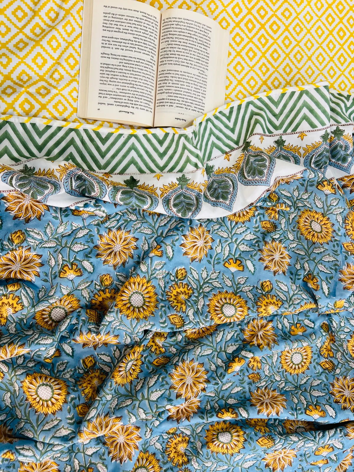 Handblock printed reversible muslin cotton dohar featuring sunflower floral motifs in blue and ivory by House Of Manjari.