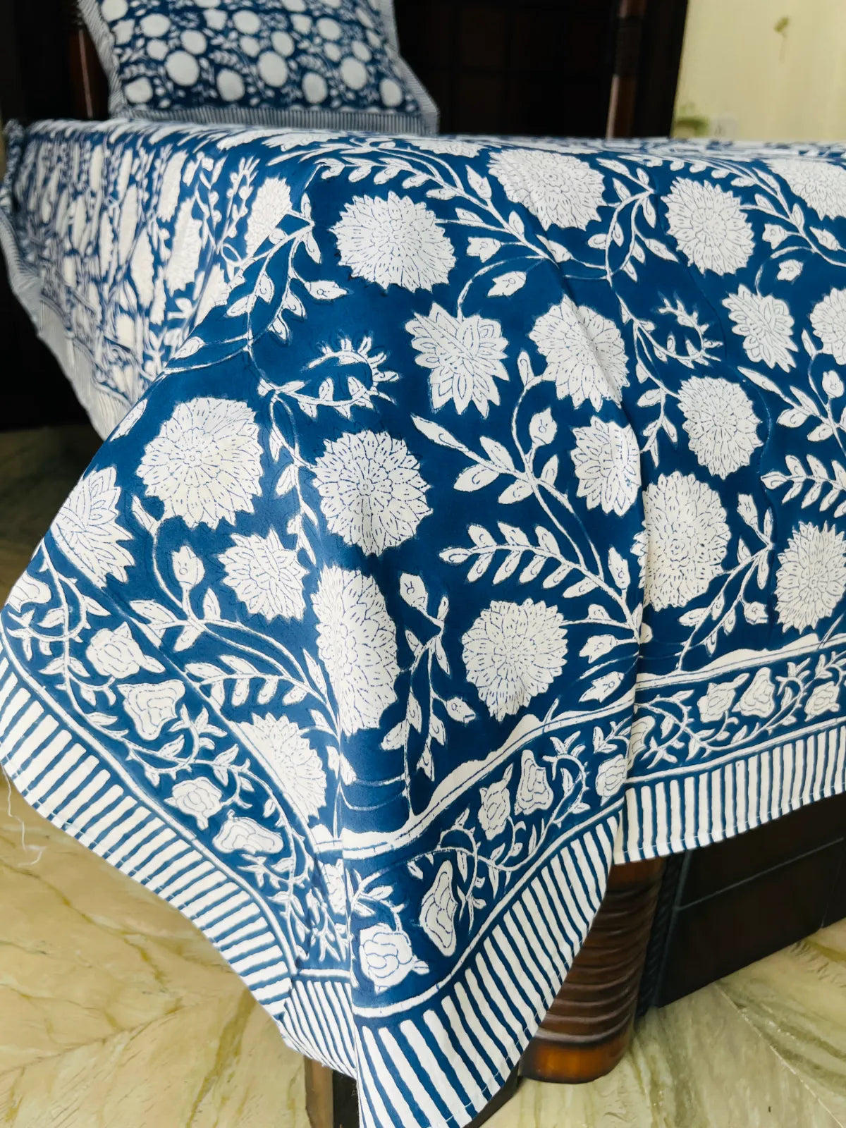 Blue floral single bedsheet in cotton with handblock print on bed