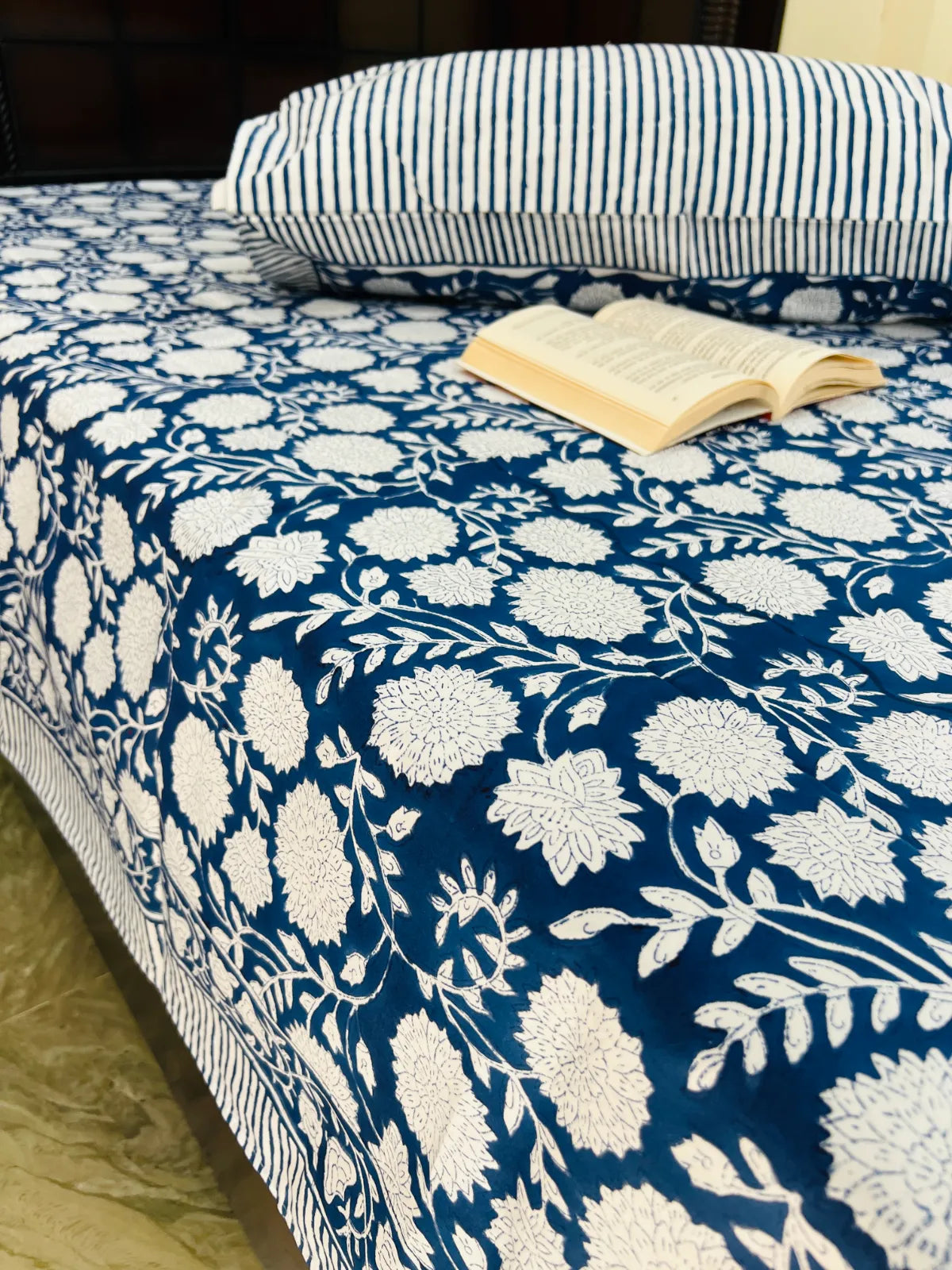 Elegant blue floral single bedsheet styled in bedroom