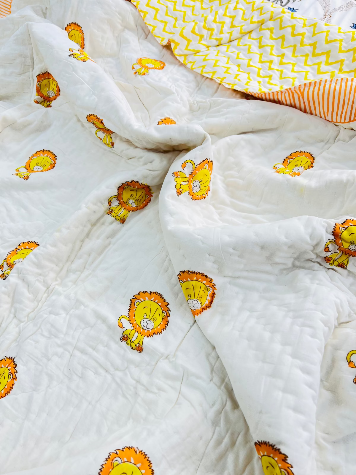 White quilt with orange lion prints on a white background